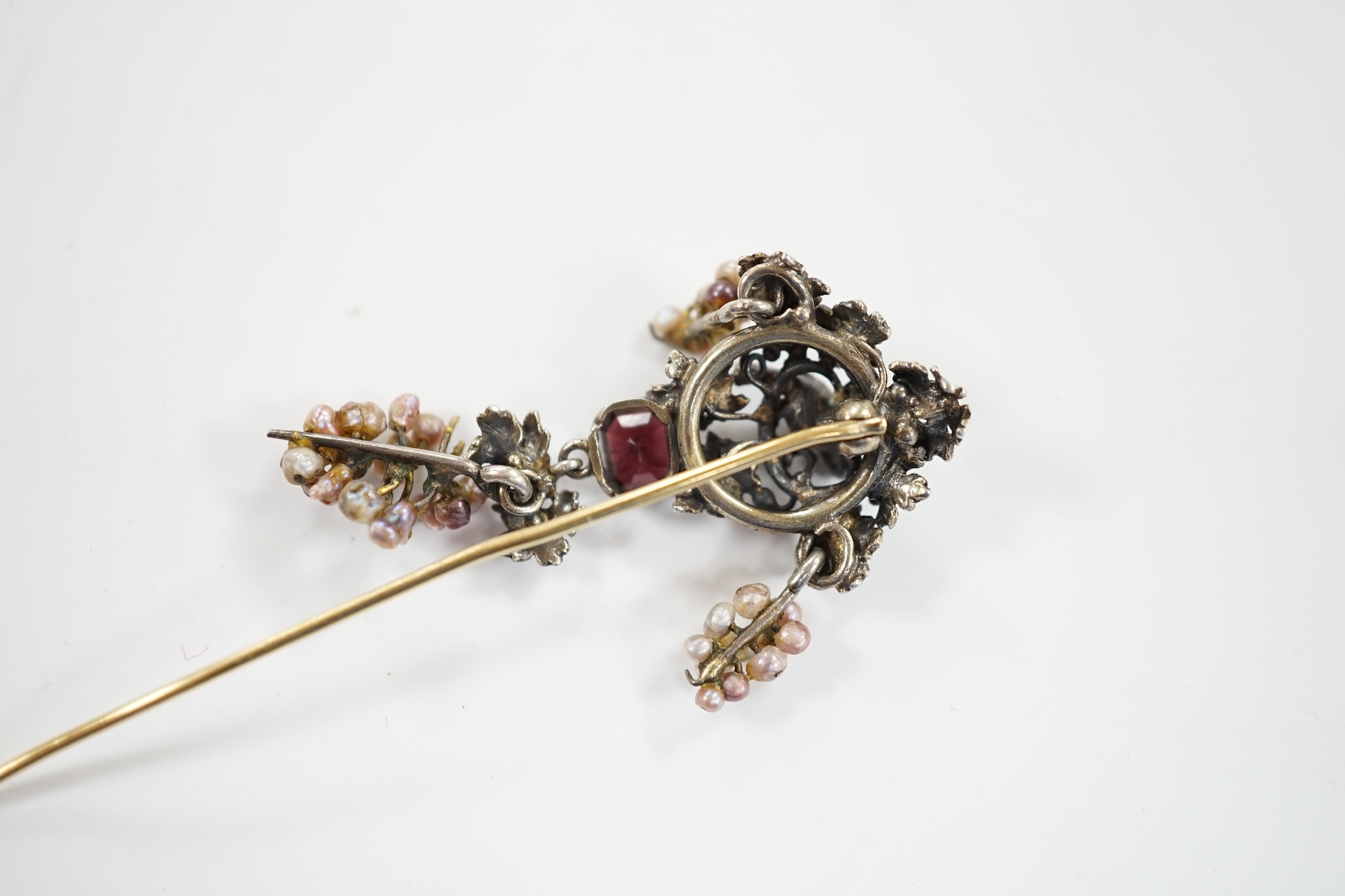 A 19th century Austro-Hungarian white metal garnet, enamel and seed baroque pearl set stick pin (adapted), 84mm.